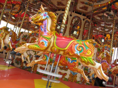 Photo of a very colourful horse on a carousel
